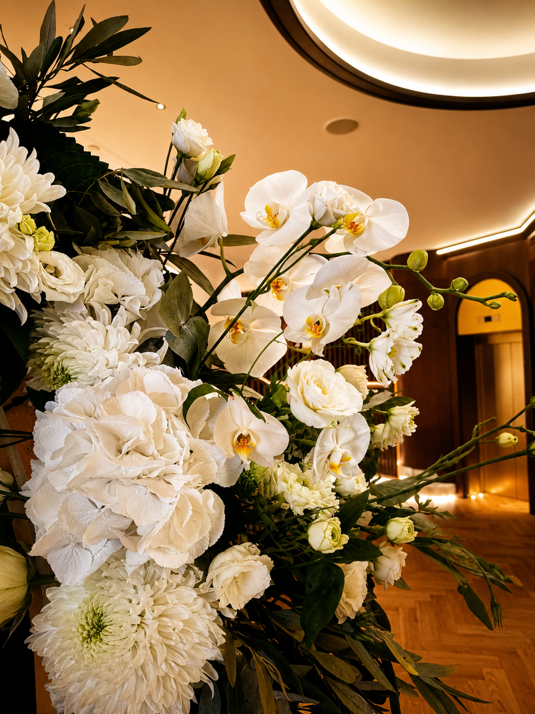 Luxury white wedding flowers in Greece with hydrangeas, orchids and roses